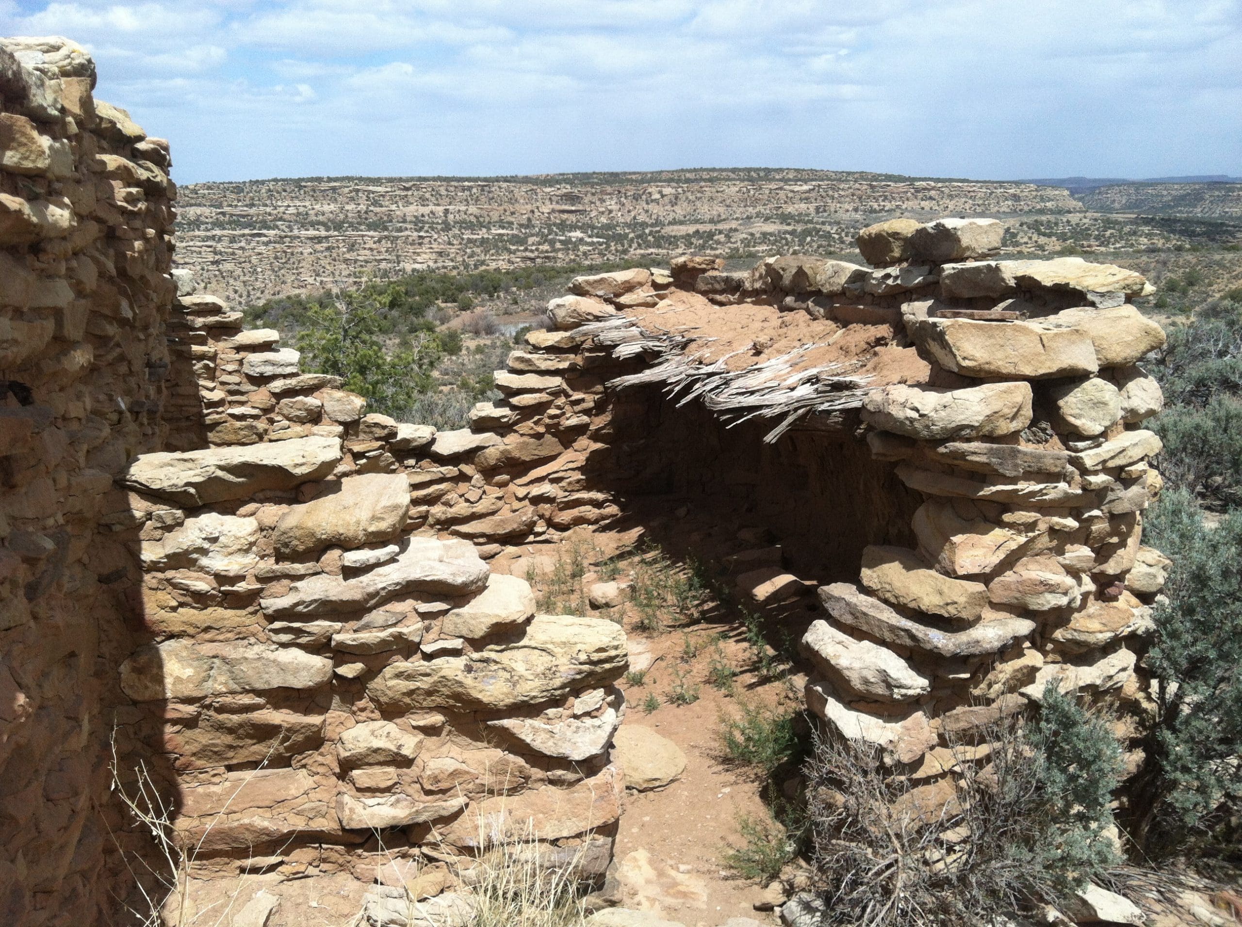 Cultural Resource Assessment Banner image -Survey & identify potential Cultural and Historical resources that may be eligible for listing in the National Register of Historic Places. A close-up of a stone historical building overlooking American Desert.